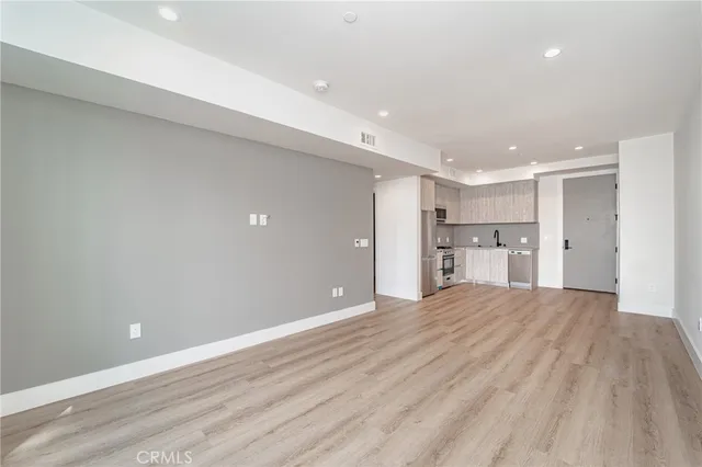 an empty room with wooden floor and a window