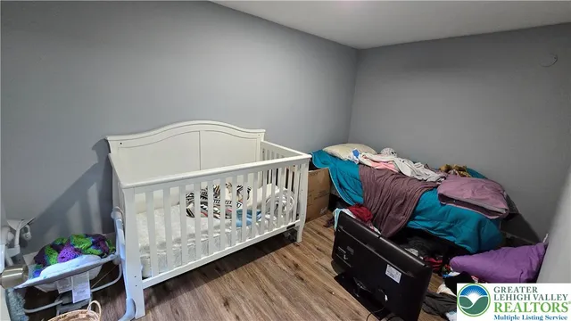 a bedroom with furniture and a baby crib