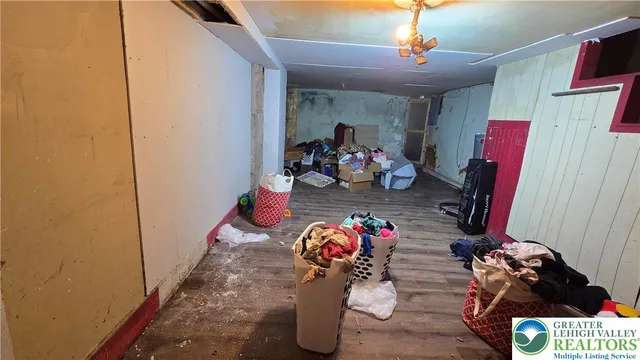 a living room with furniture a rug and a large window