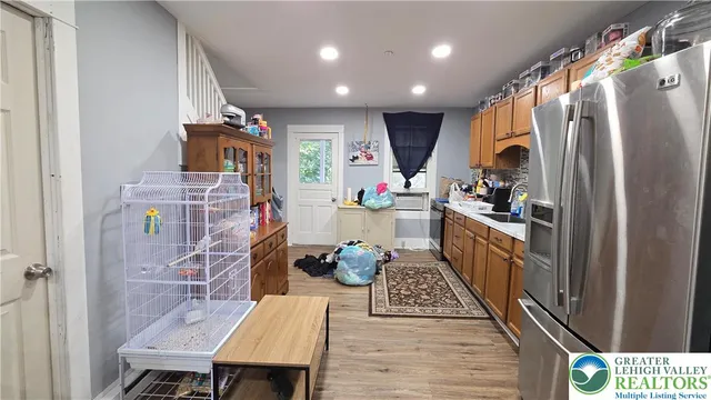 a kitchen with refrigerator and window