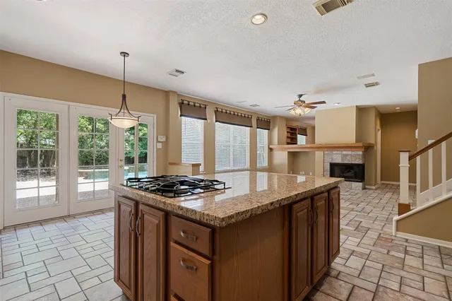 a kitchen with stainless steel appliances granite countertop a stove a sink and a refrigerator