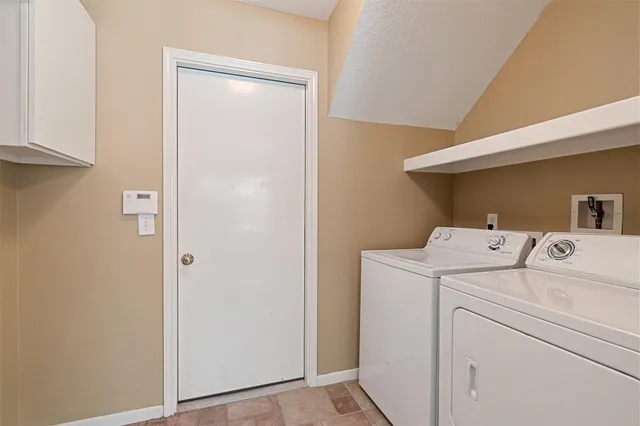 a view of storage and utility room with washer and dryer
