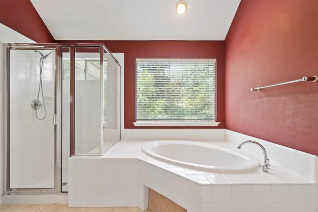 a bathroom with a bathtub and a shower