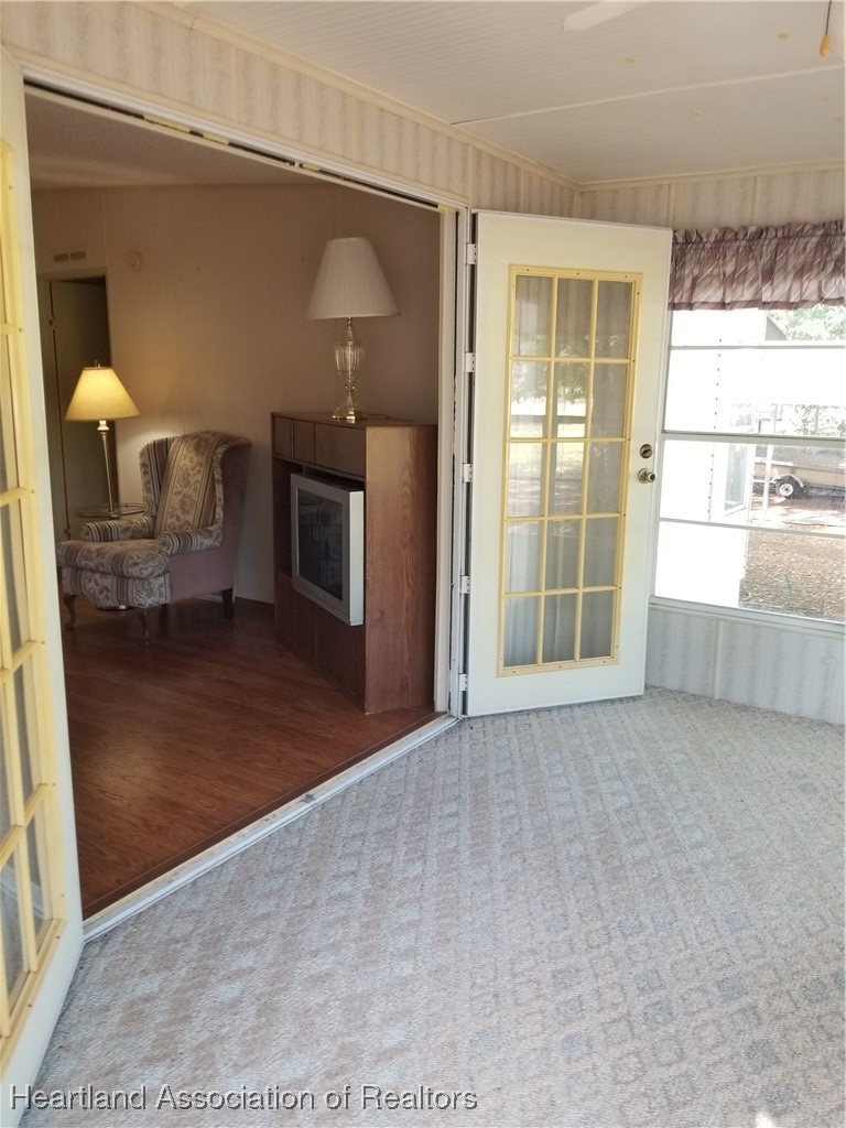 9125 Spur Path Sebring, FL 33875 - Photo 19 of 31 French doors at front porch of house leading into living room