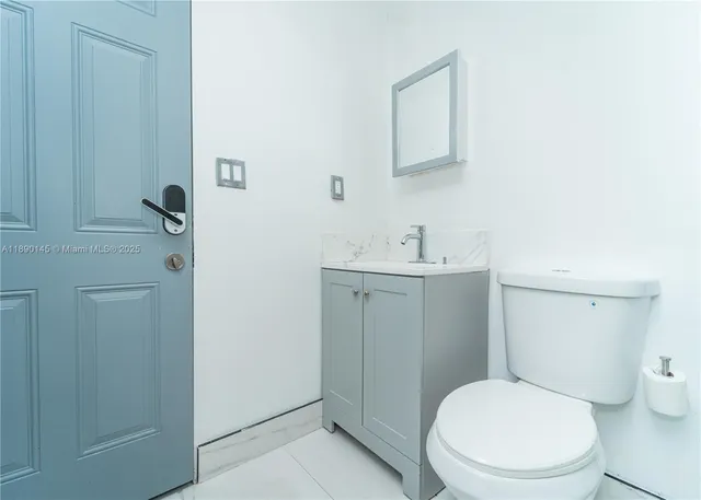 a white toilet sitting next to a bathroom sink