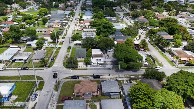 an aerial view of residential houses with outdoor space and street view