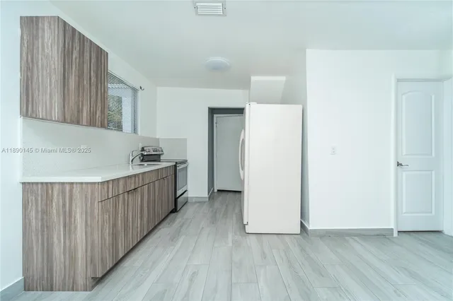 a view of a room with wooden floor