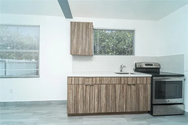 a kitchen with a window a sink and a cabinets