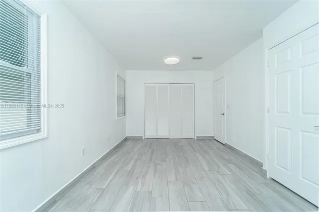 an empty room with wooden floor