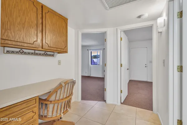 a bedroom with a bed and a chandelier fan