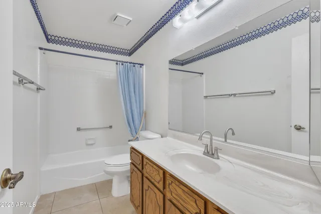 a bedroom with a bed and a ceiling fan