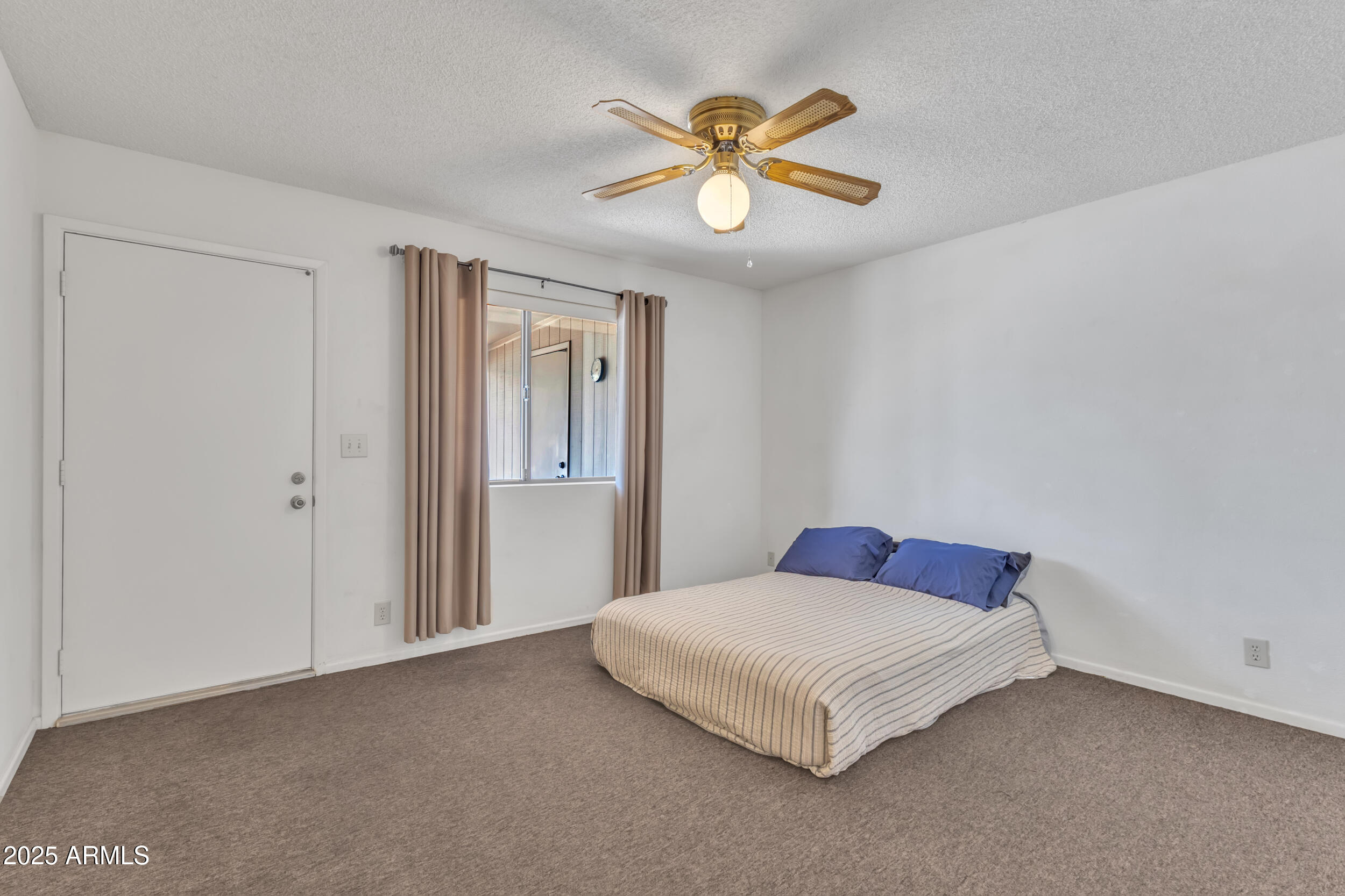 520 South Greenfield Road, Unit 13 Mesa, AZ 85206 - Photo 19 of 44 a bedroom with a bed and a ceiling fan