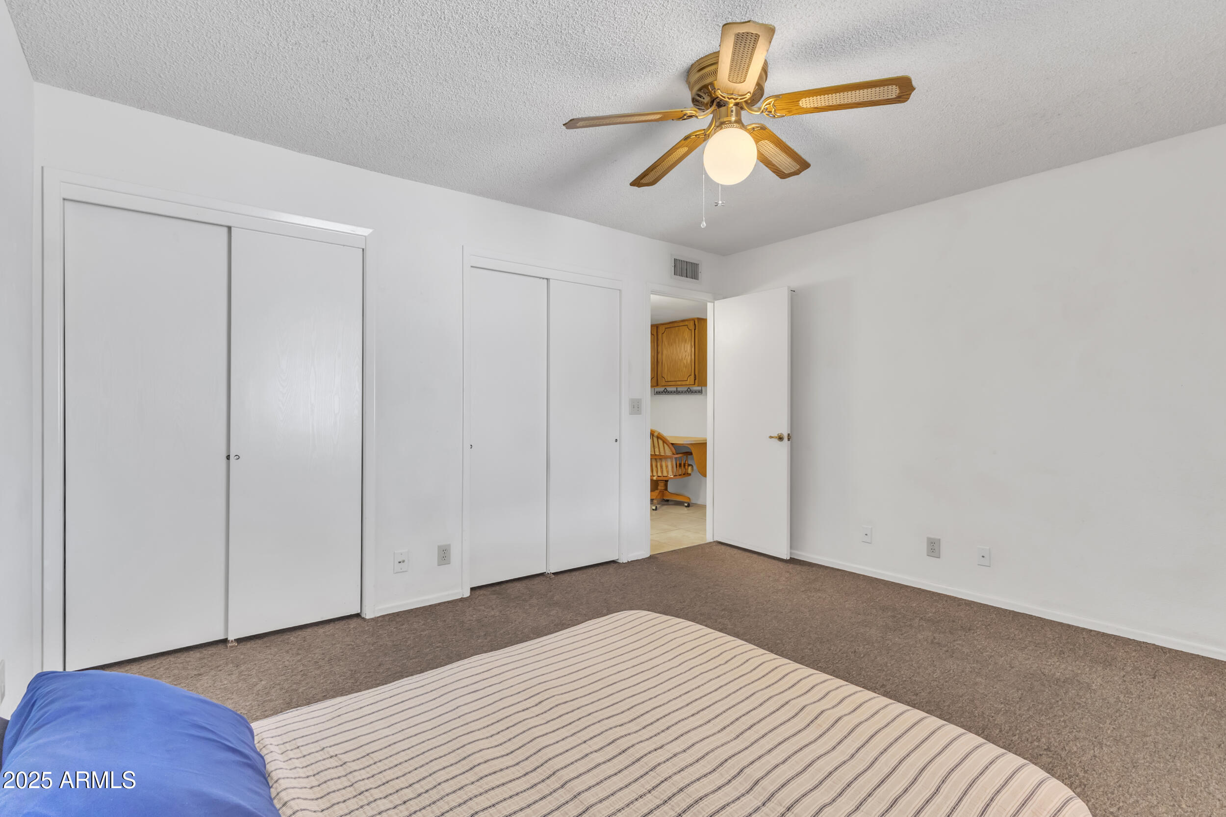 520 South Greenfield Road, Unit 13 Mesa, AZ 85206 - Photo 20 of 44 a bedroom with a bed and a chandelier fan