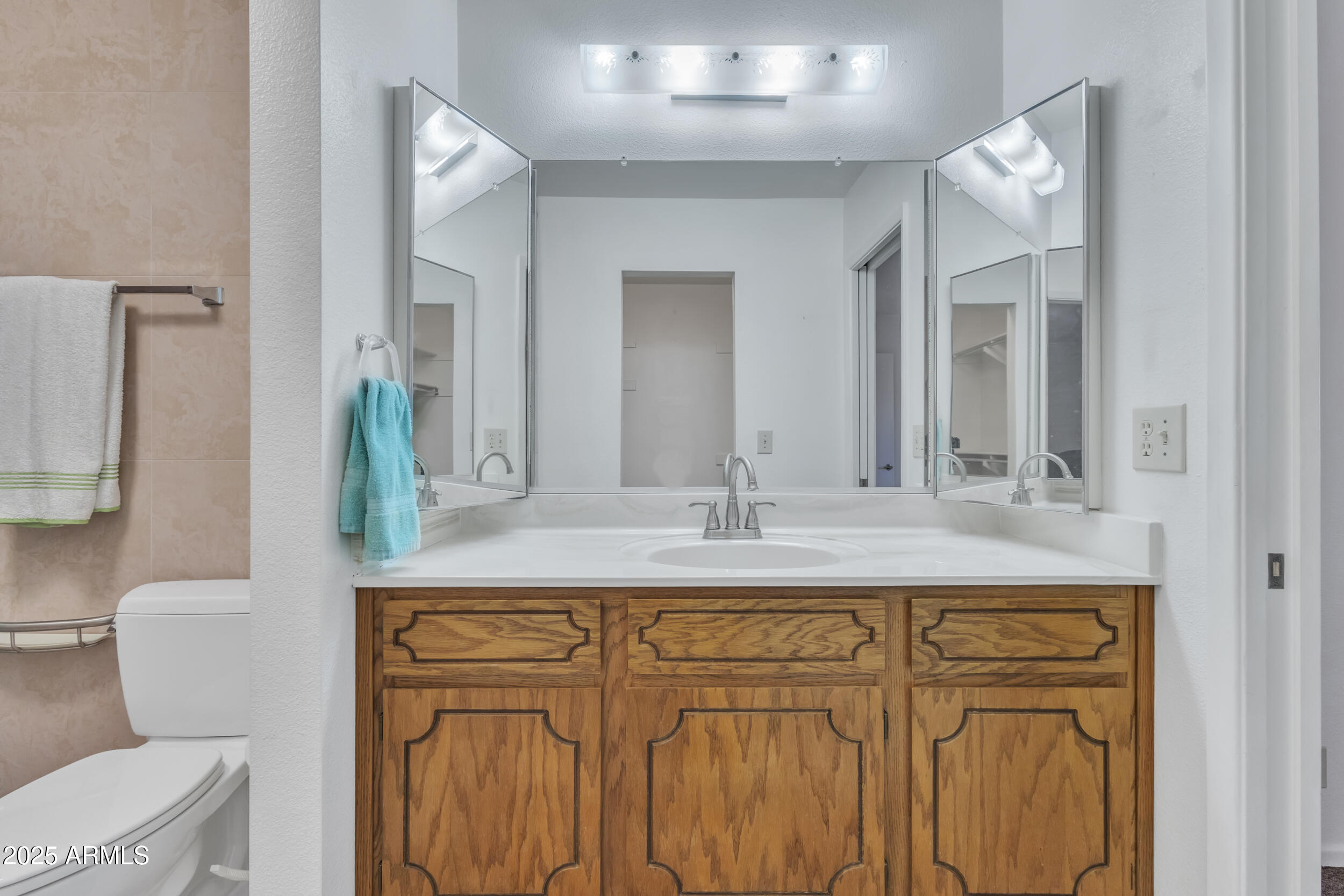 520 South Greenfield Road, Unit 13 Mesa, AZ 85206 - Photo 25 of 44 a bathroom with a granite countertop sink mirror vanity and toilet