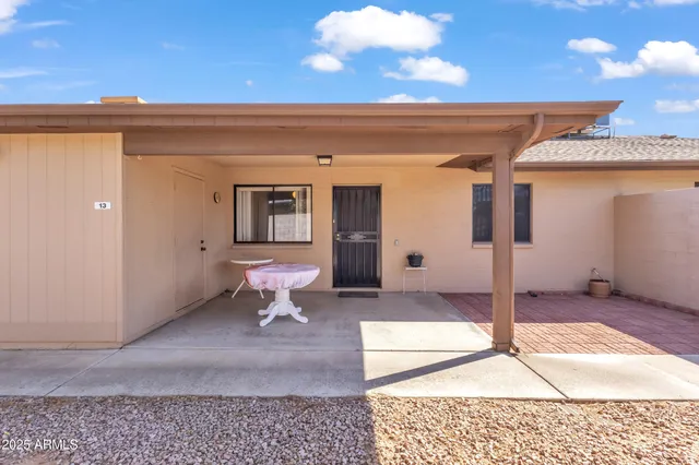 a backyard of a house with table and chairs