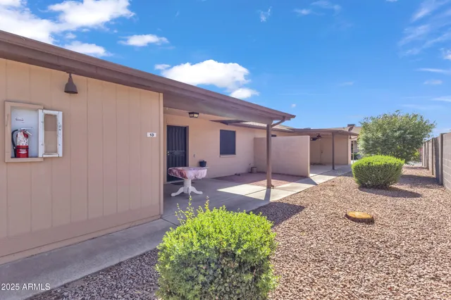 an aerial view of a house with garden space and street view