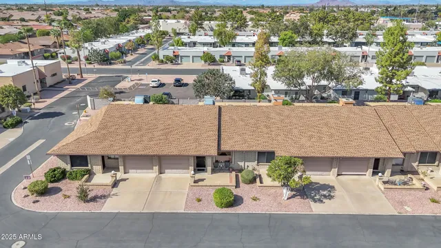 an aerial view of a house with garden space and street view