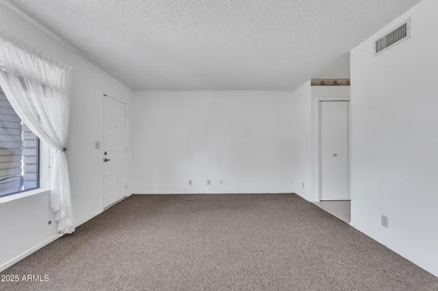 a view of a livingroom and a livingroom with furniture