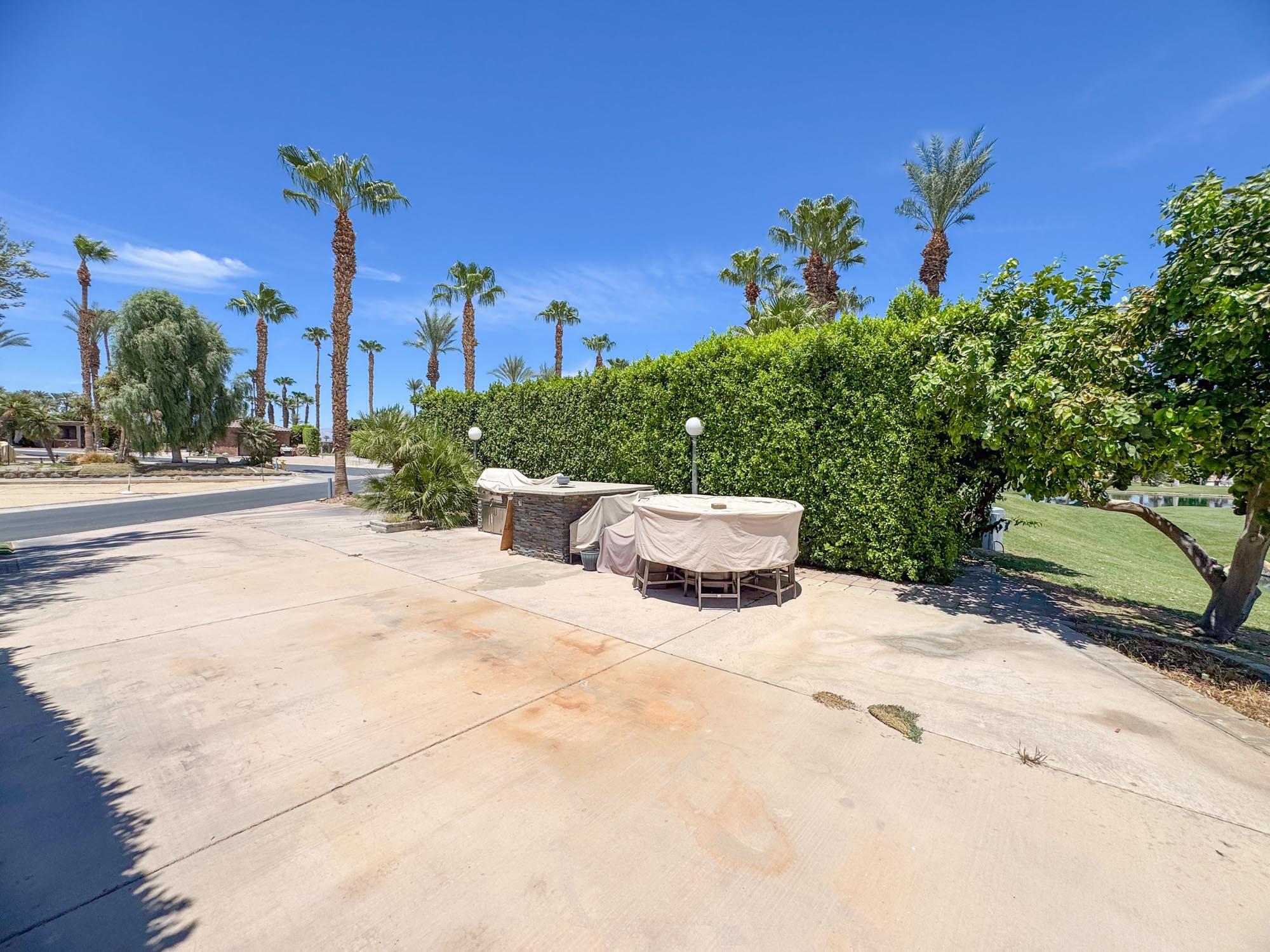 80394 Ave 48, Unit 423 Indio, CA 92201 - Photo 11 of 18 a white house with a yard and plants