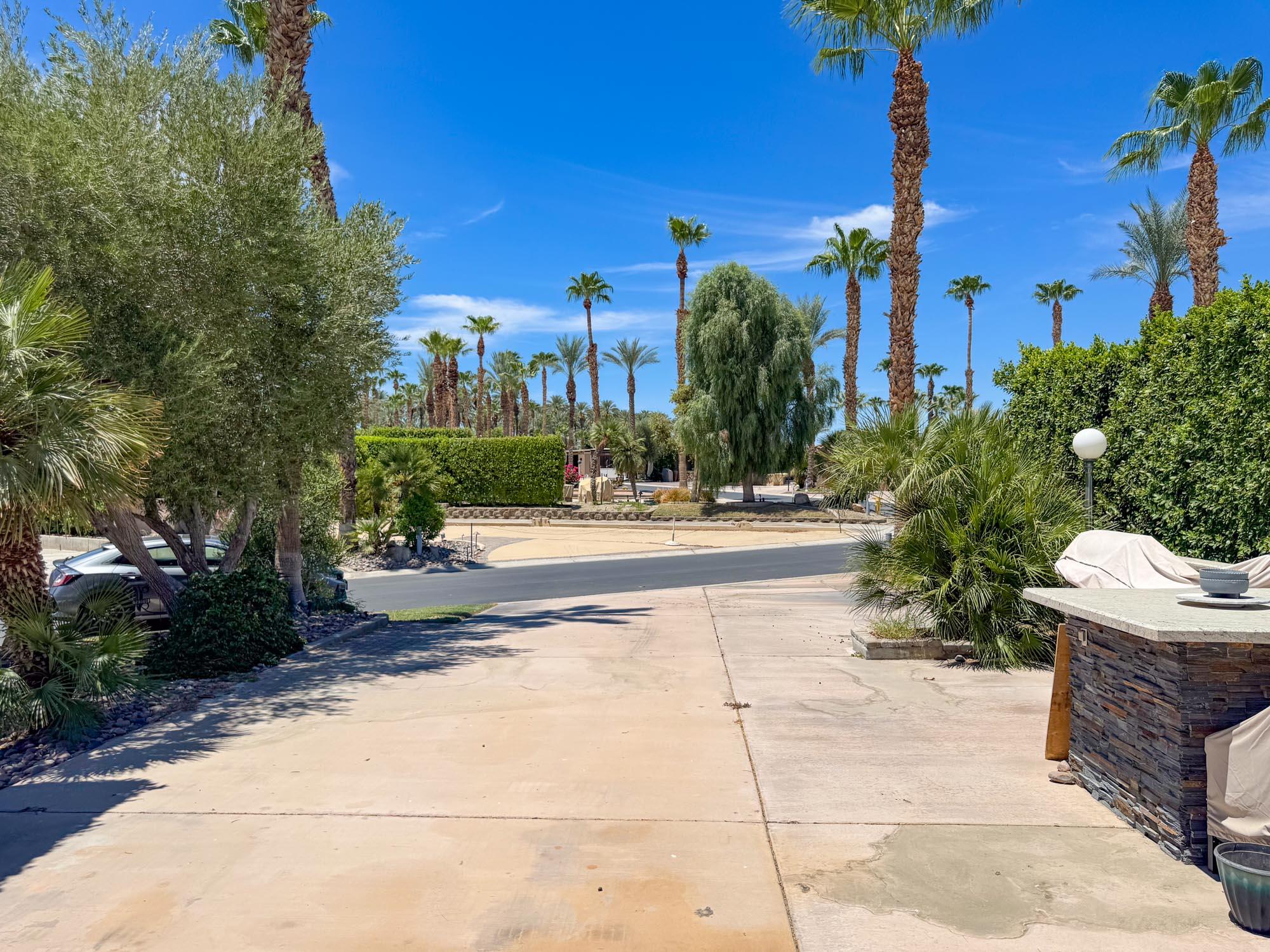 80394 Ave 48, Unit 423 Indio, CA 92201 - Photo 17 of 18 a view of a patio with plants and palm trees