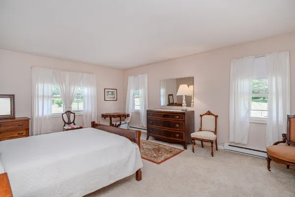 a bedroom with a bed furniture and a window