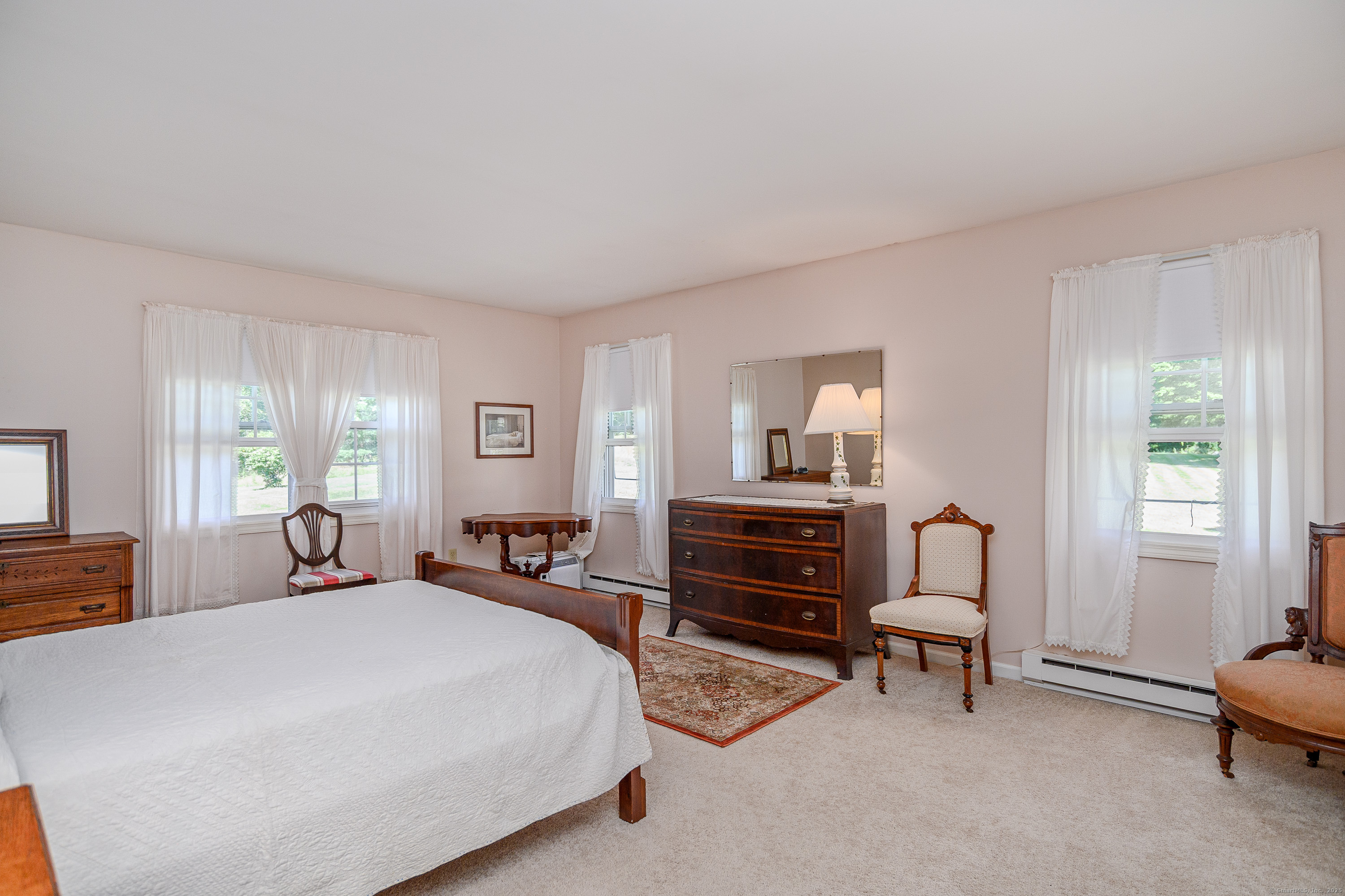 a bedroom with a bed furniture and a window