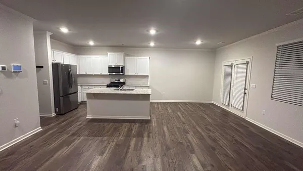 a kitchen with stainless steel appliances a refrigerator and a stove top oven
