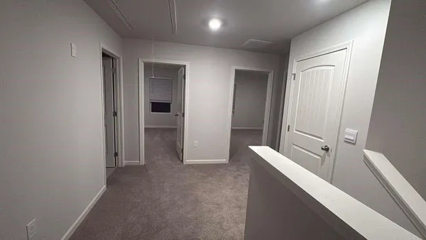a view of hallway with bathroom