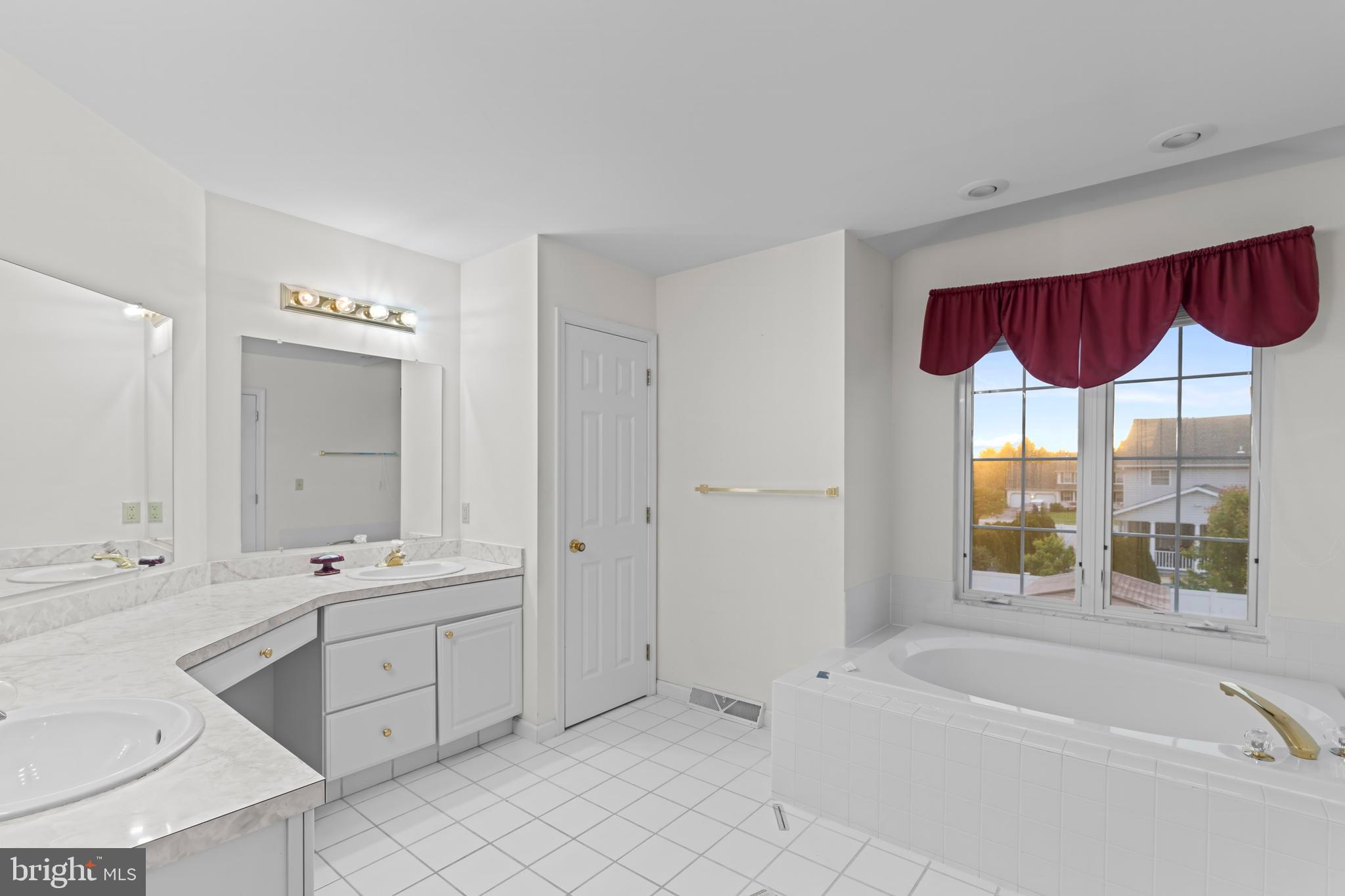 1004 Hostetter Road Hanover, PA 17331 - Photo 13 of 15 a bathroom with a sink a large mirror and a bathtub next to a window