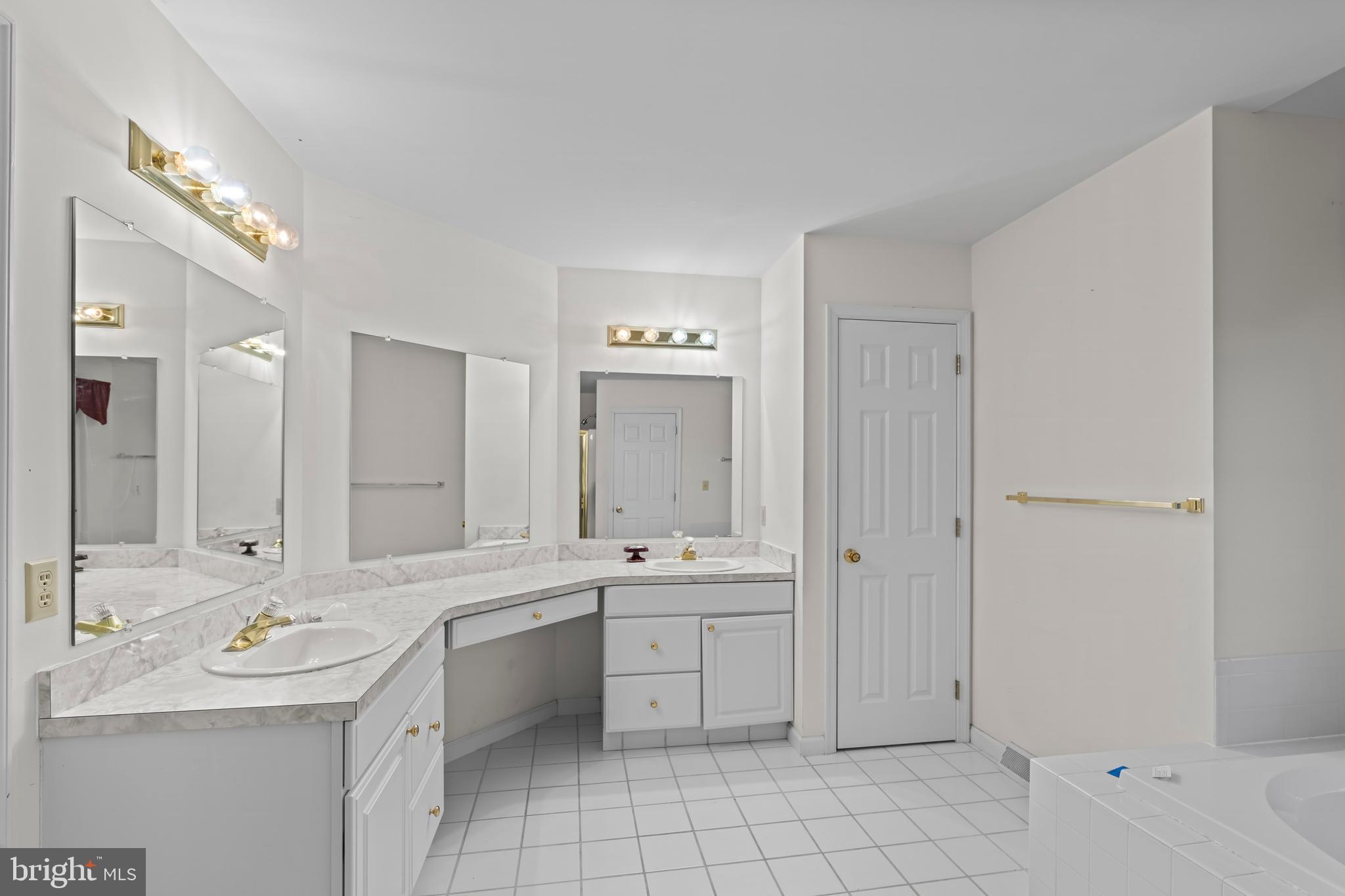 1004 Hostetter Road Hanover, PA 17331 - Photo 14 of 15 a bathroom with a double vanity sink a mirror and a bathtub
