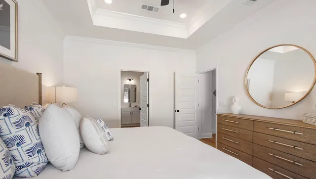 a bedroom with a bed mirror and window