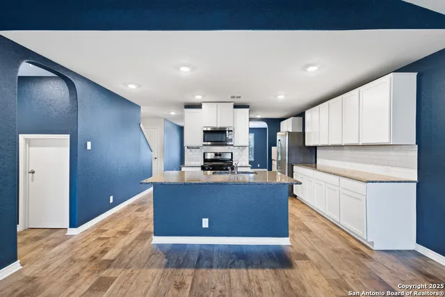 a view of a room with wooden floor and windows