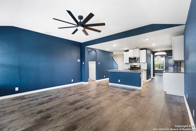a view of a livingroom with a hardwood floor and a ceiling fan