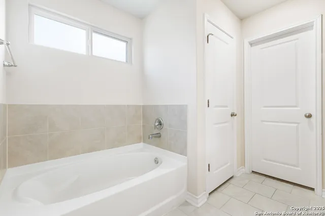 a bathroom with a glass shower door
