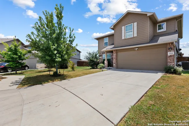 a front view of a house with a yard and a garage