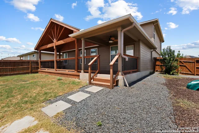 a picture of a table and chairs with potted plants