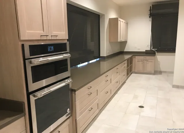 a view of a room with gym equipment and large windows