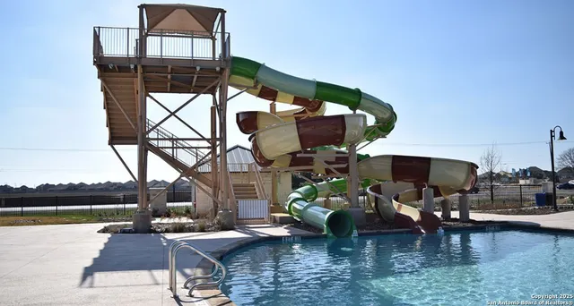 a view of a patio with table and chairs a barbeque with wooden floor and fence