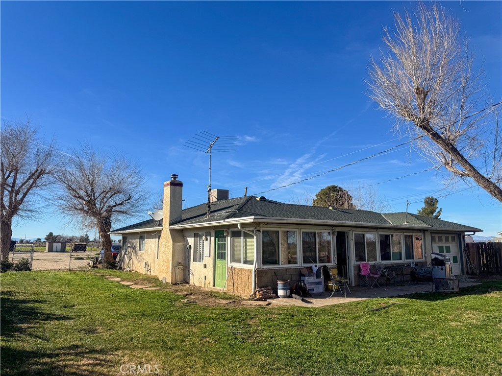 44665 95th Street East Lancaster, CA 93535 - Photo 12 of 34 a front view of a house with garden