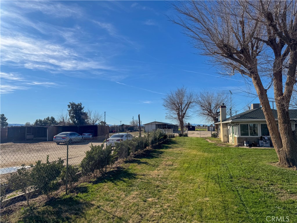 44665 95th Street East Lancaster, CA 93535 - Photo 16 of 34 a view of a chairs in a backyard of a house