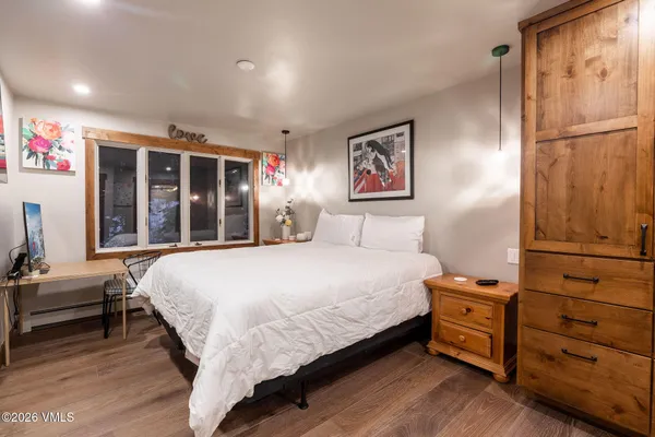 a bedroom with a bed and a window