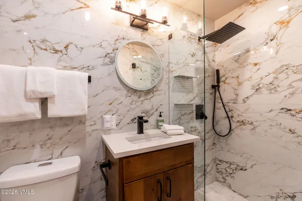 a bathroom with a sink toilet and shower