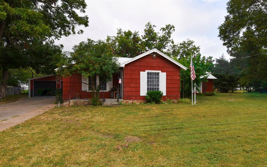 a view of a house with a yard and garage
