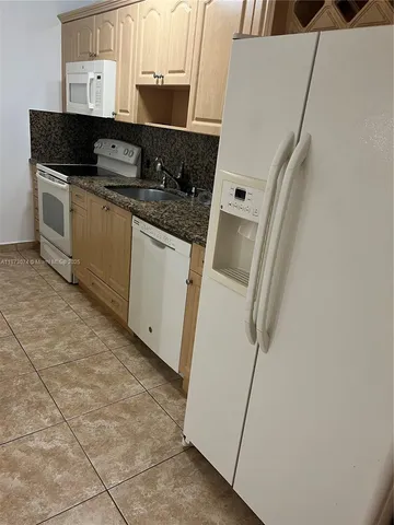 a kitchen with a sink and a stove top oven