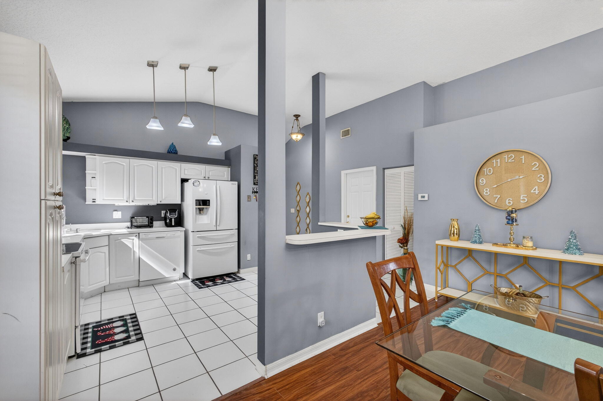 5156 Elpine Way Riviera Beach, FL 33418 - Photo 12 of 97 a kitchen with a dining table chairs and cabinets