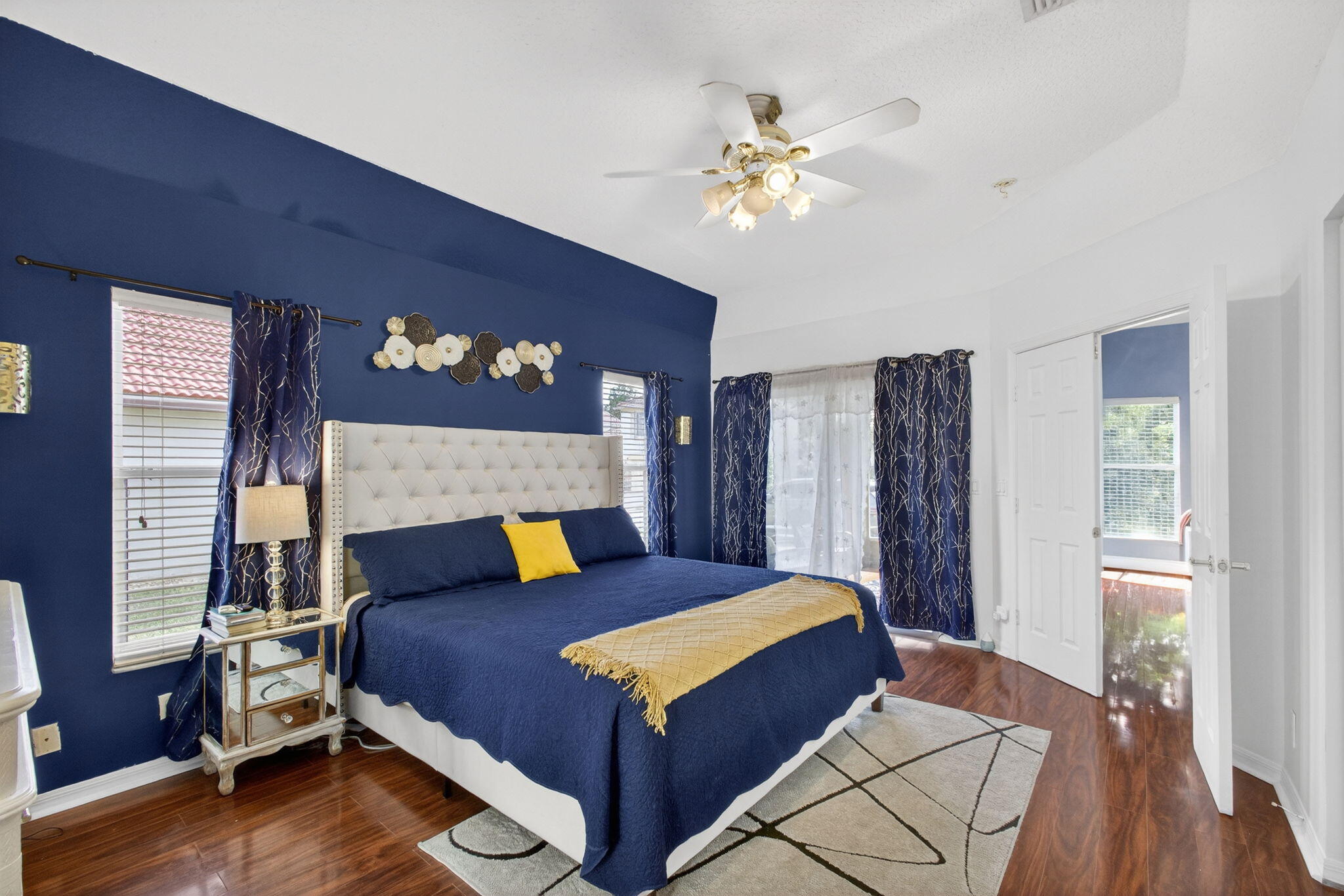 5156 Elpine Way Riviera Beach, FL 33418 - Photo 30 of 97 a bedroom with a large bed and a chandelier