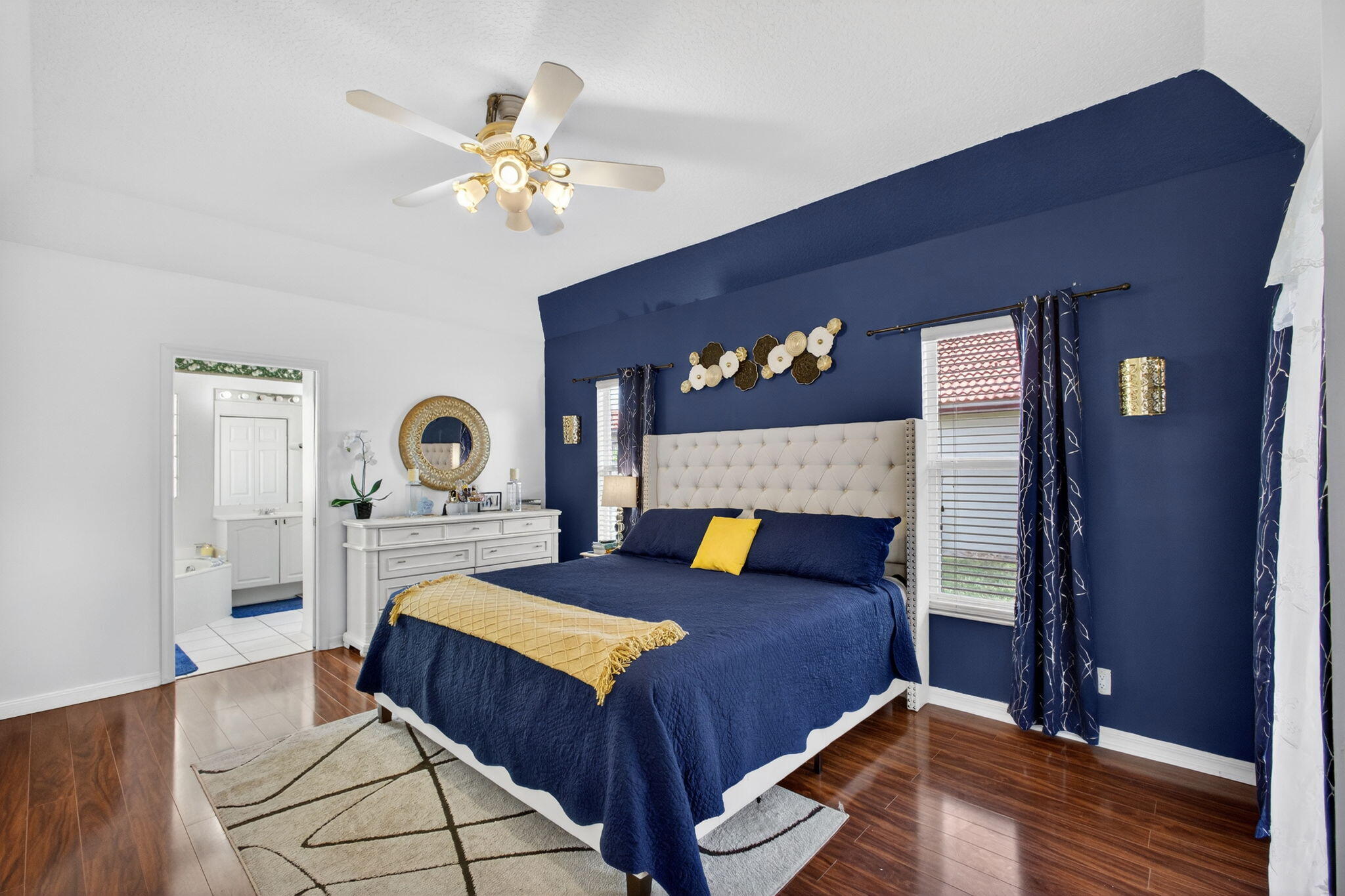 5156 Elpine Way Riviera Beach, FL 33418 - Photo 32 of 97 a bedroom with a bed and a chandelier