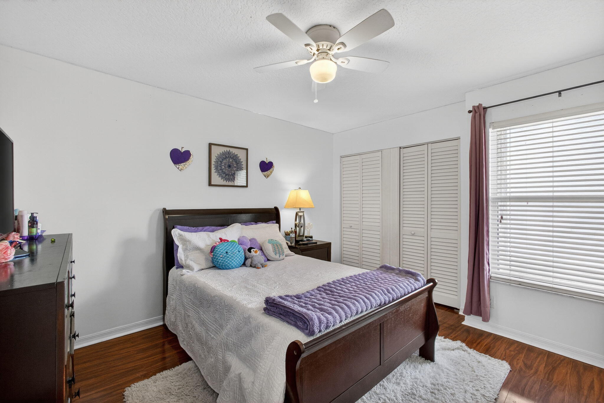 5156 Elpine Way Riviera Beach, FL 33418 - Photo 45 of 97 a bedroom with a bed and a chandelier