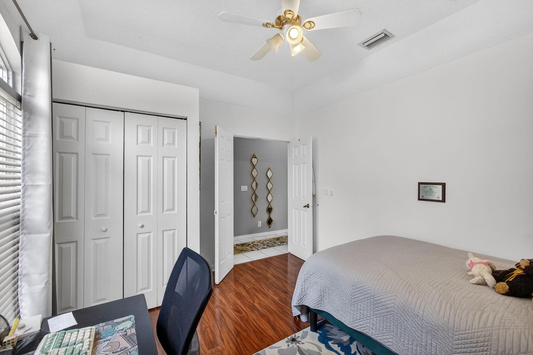 5156 Elpine Way Riviera Beach, FL 33418 - Photo 9 of 97 a bedroom with a bed and a chandelier