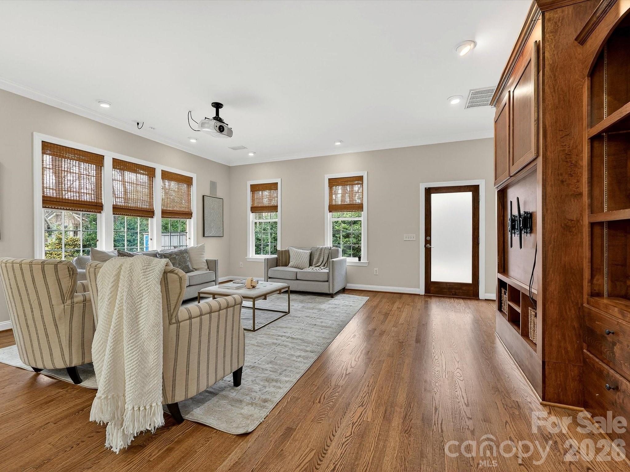 6344 Dovefield Road Charlotte, NC 28277 - Photo 18 of 46 a living room with furniture floor to ceiling window and wooden floor